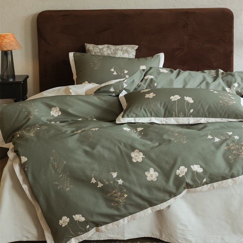 Cotton satin bedding set with subtle botanical print and contrasting hem edge