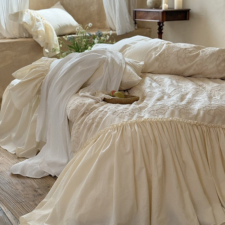 Vintage-inspired bed skirt and bedspread with wide ruffle and delicate embroidery