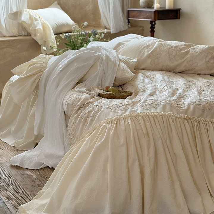 Vintage-inspired bed skirt and bedspread with wide ruffle and delicate embroidery