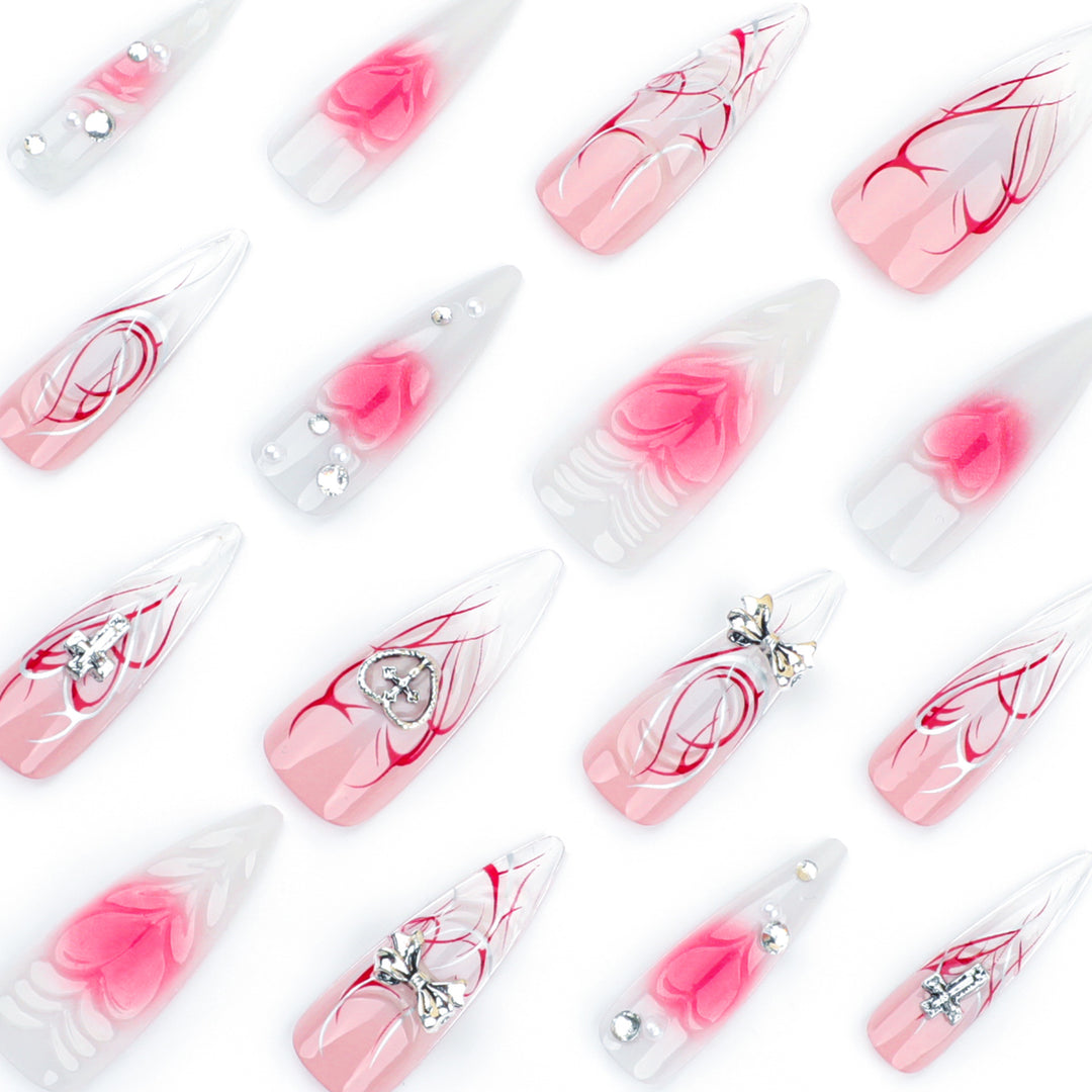 Artful stiletto nails with elegant floral accents and glitter embellishments Kalsten