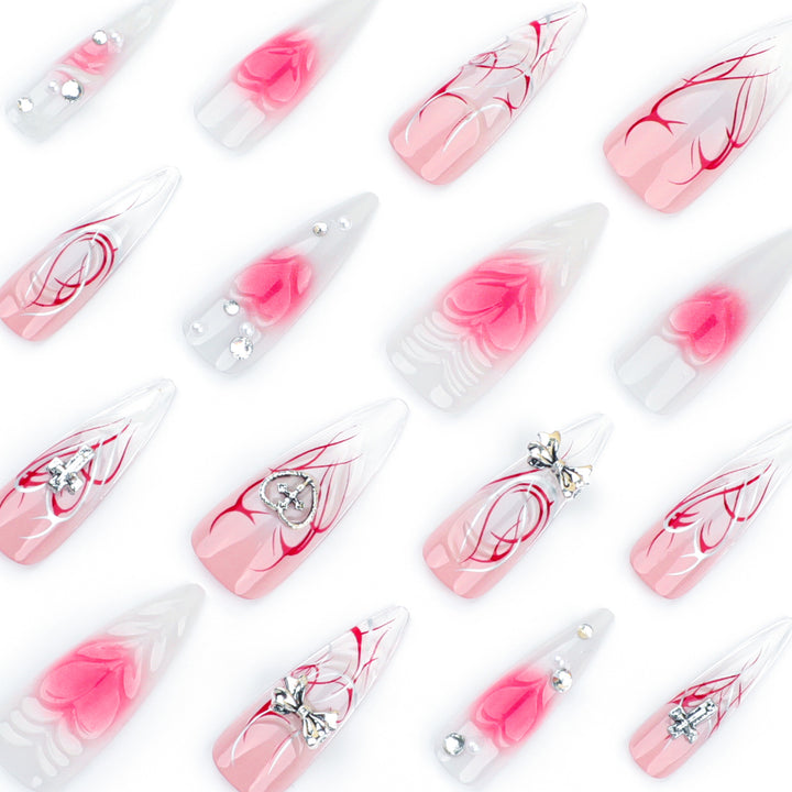 Artful stiletto nails with elegant floral accents and glitter embellishments Kalsten