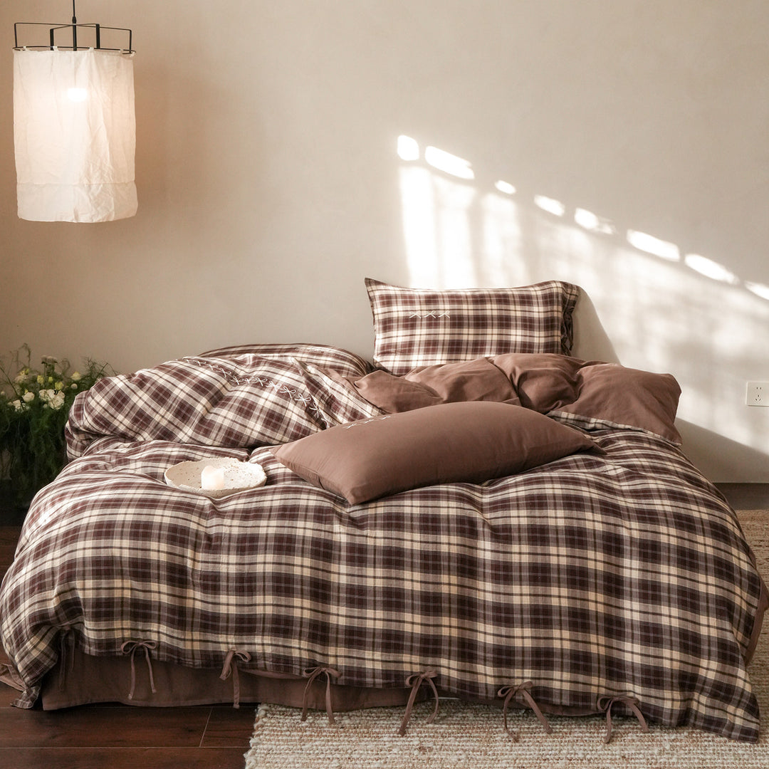 Checked cotton bedding set with decorative ribbons, ruffles, and subtly embroidered detail