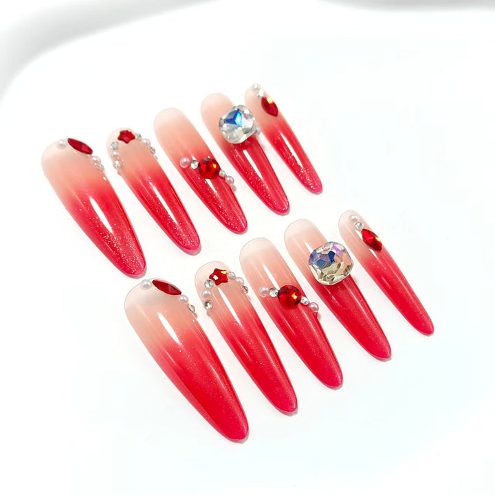Artificial nails in elegant ombre style with glitter and jewelry accents Kalsten