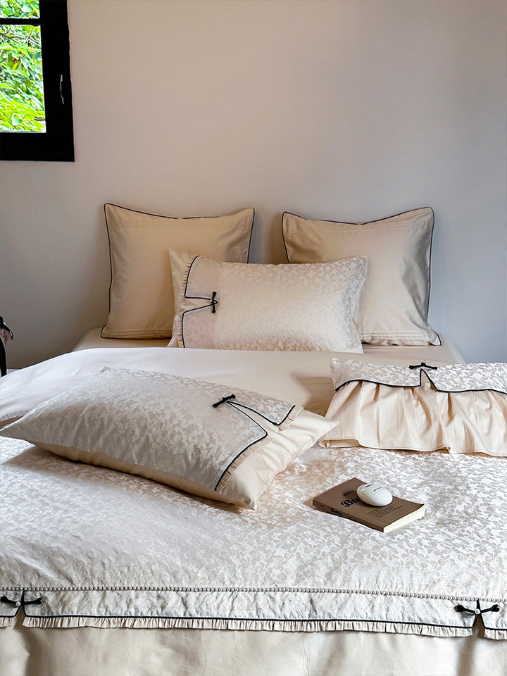 Elegant jacquard bedding set with floral relief structure, ruffles and contrasting piping