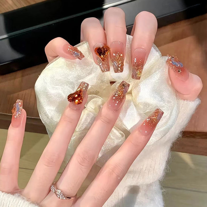 Artistic acrylic nails with heart design and sparkling accents Kalsten