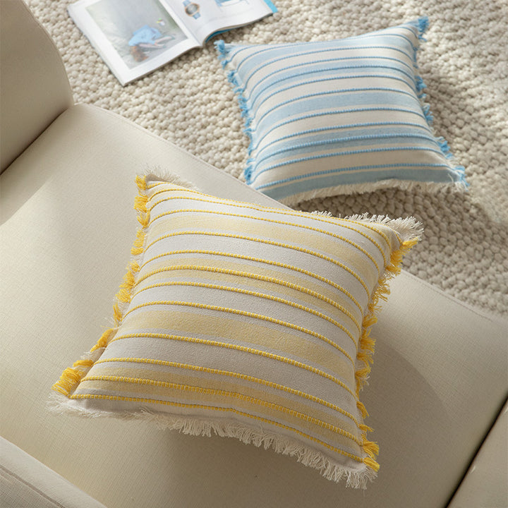 Square cushion cover made of hand-woven cotton blend with decorative fringe trim Kalsten