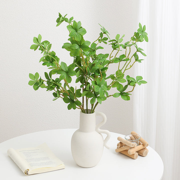 Decorative artificial branch with vibrant leaves