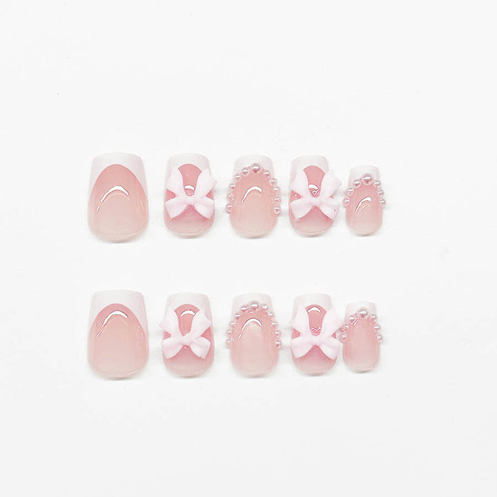 Artificial nails with elegant bows and pearl embellishments Kalsten