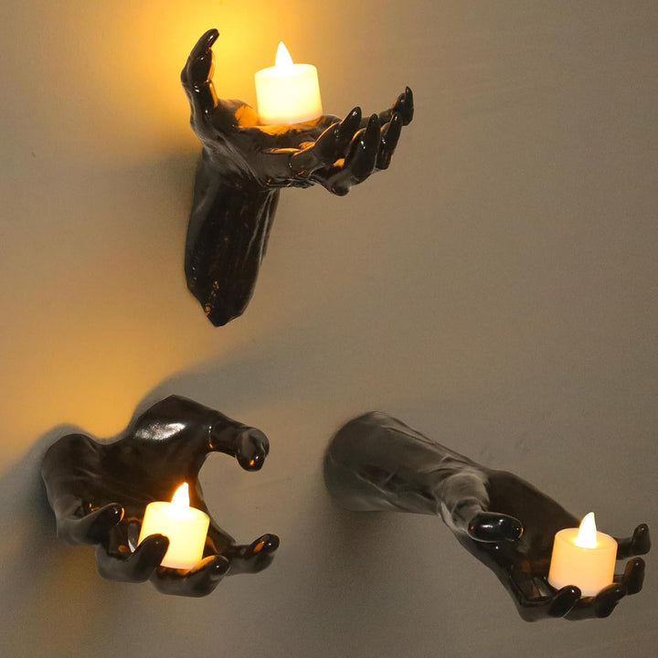 Wall candle holder in realistically shaped hand made of resin