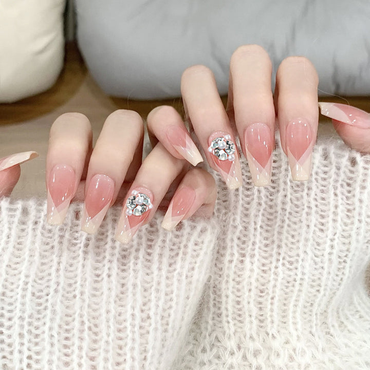 Artificial nail set with filigree tip designs and glamorous rhinestone accents Kalsten
