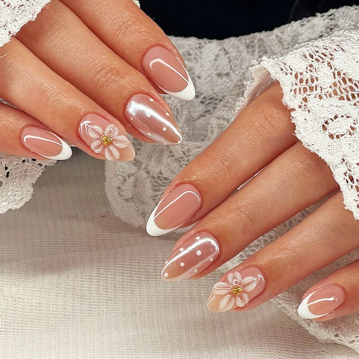 Artificial nail set with elegant French tips and delicate floral accents Kalsten