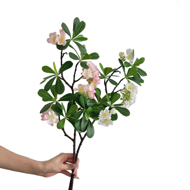 Artificial flower branch with fine pink flowers and vibrant leaves
