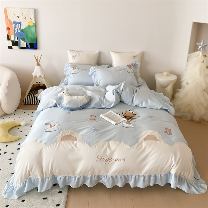 Playful satin bedding set with ruffled border, appliqués and quilted head section