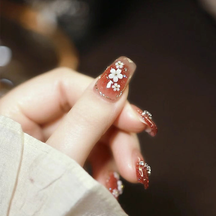 Artistic Press-On Nail Art with Floral and Glitter Accents Kalsten