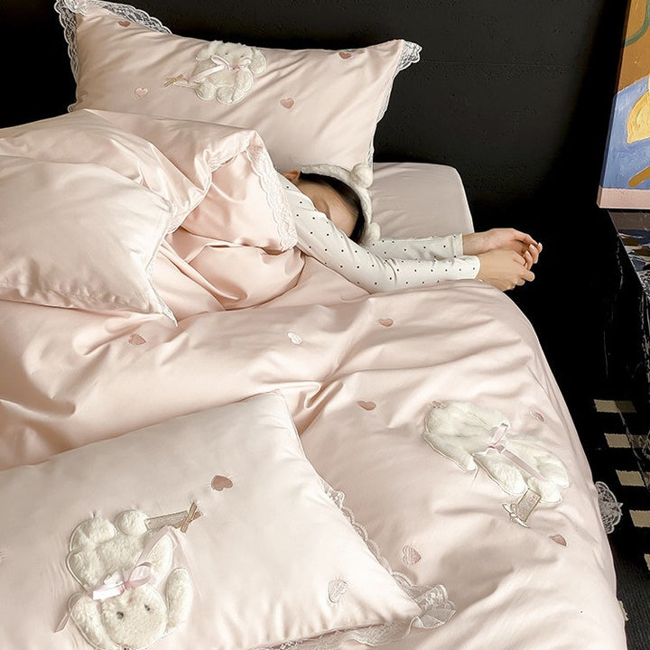 Luxurious satin bedding set with plush bunny appliqué and lace trim