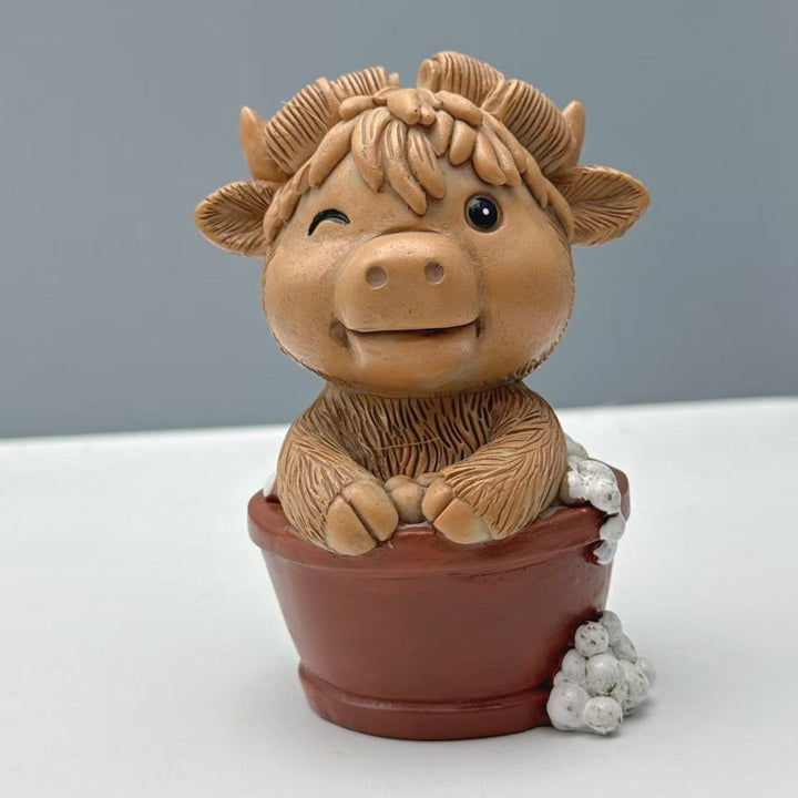 Funny decorative figure of a Highland cow on toilet Kalsten