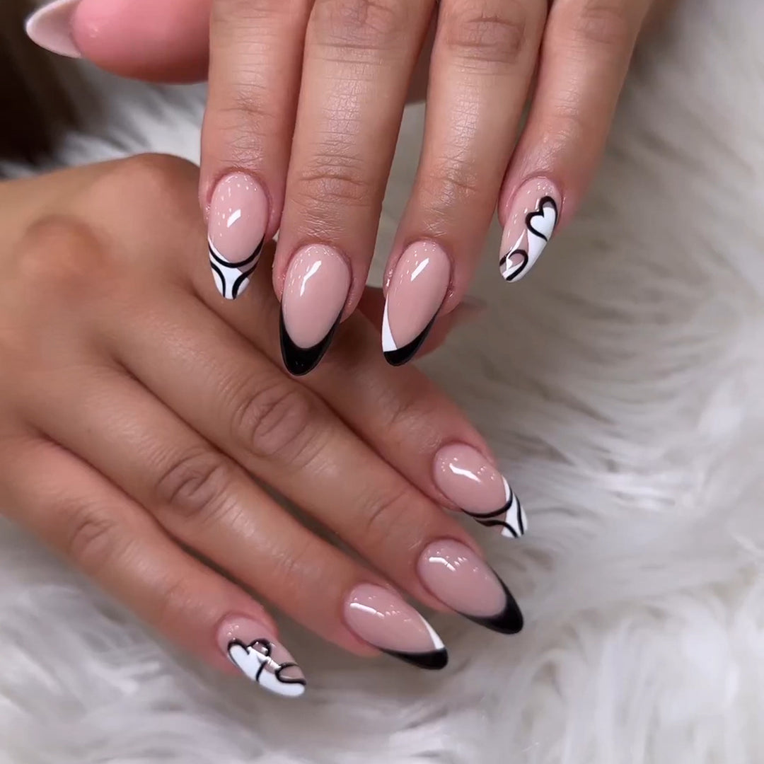 Artful stiletto nails with elegant black-and-white design Kalsten