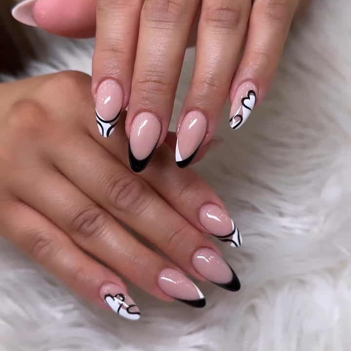 Artful stiletto nails with elegant black-and-white design Kalsten