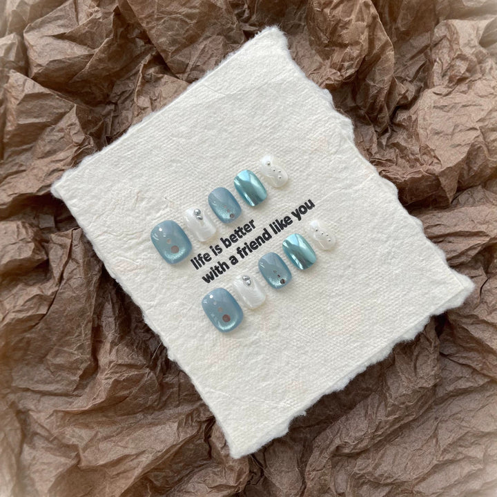 Artistic Press-On Nail Art Set with Unique Button and Ocean-Inspired Designs