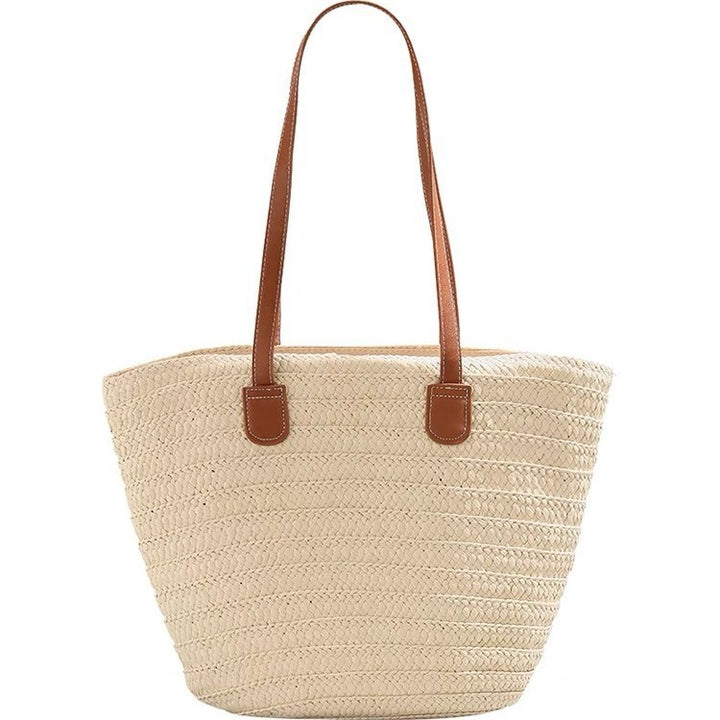 Stylish beach bag made of woven natural material with leather handles Kalsten