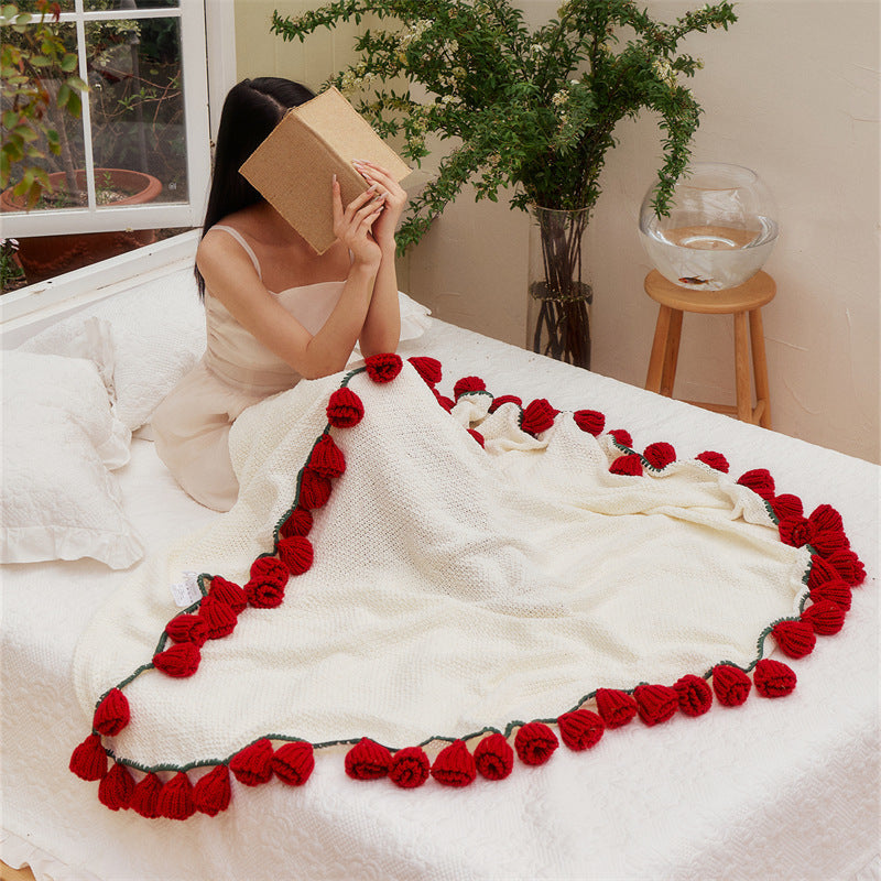 Crocheted throw blanket with 3D sunflower appliqués and chunky stitch structure