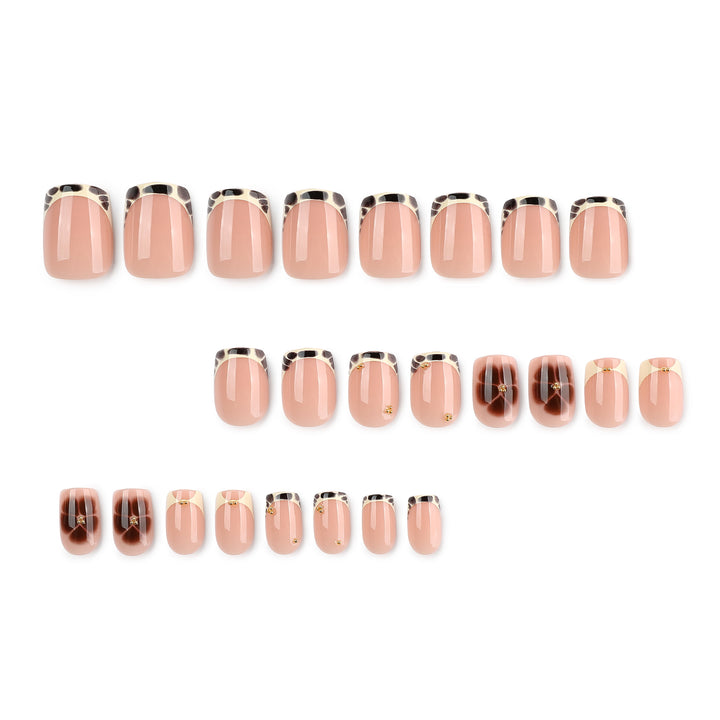 Artful nail extensions with an elegant giraffe pattern and golden accents Kalsten