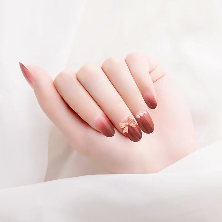 Artificial nails with glamorous bow and pearl decor Kalsten