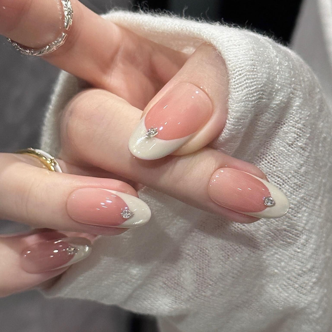 Artificial nails with elegant French style and sparkling accents Kalsten