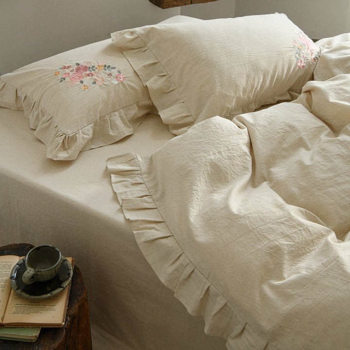 Embroidered linen-look bedding set with ruffle and floral embroidery detail