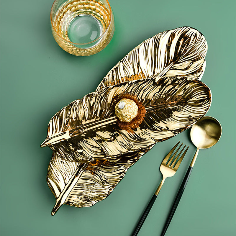 Leaf-shaped decorative tray made of metal with a textured surface