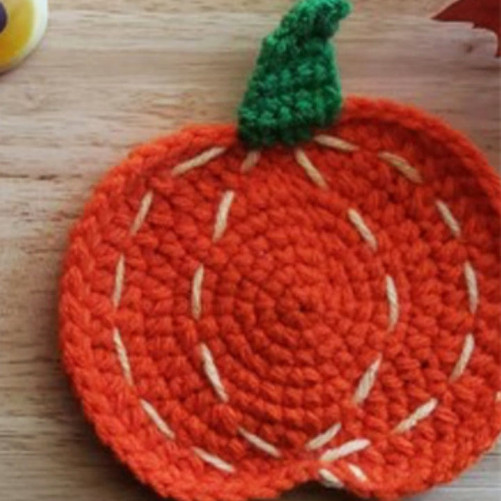 Hand-crocheted pumpkin pot holder and table mat made of cotton yarn