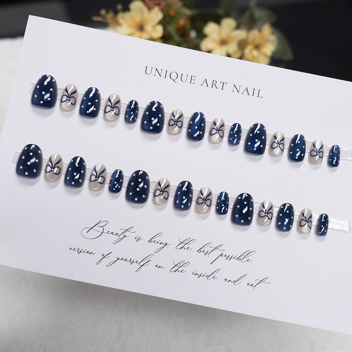 Decorative Nail Art with Bow and Polka Dot Design