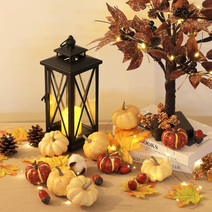 Autumn decorative set made of realistic artificial pumpkins, pine cones, acorns, and maple leaves