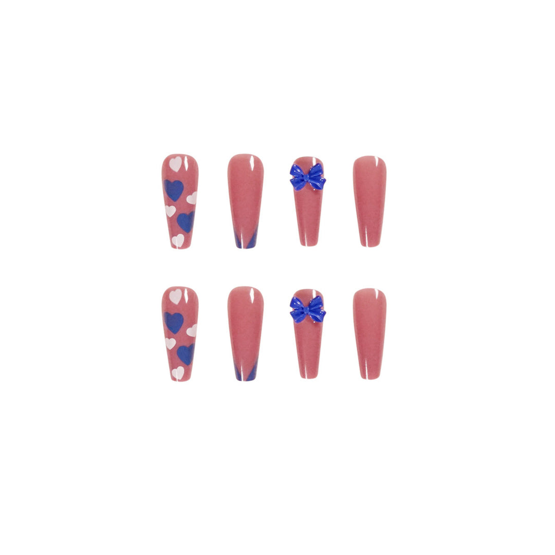 Artful stiletto nails with modern heart and bow motifs Kalsten