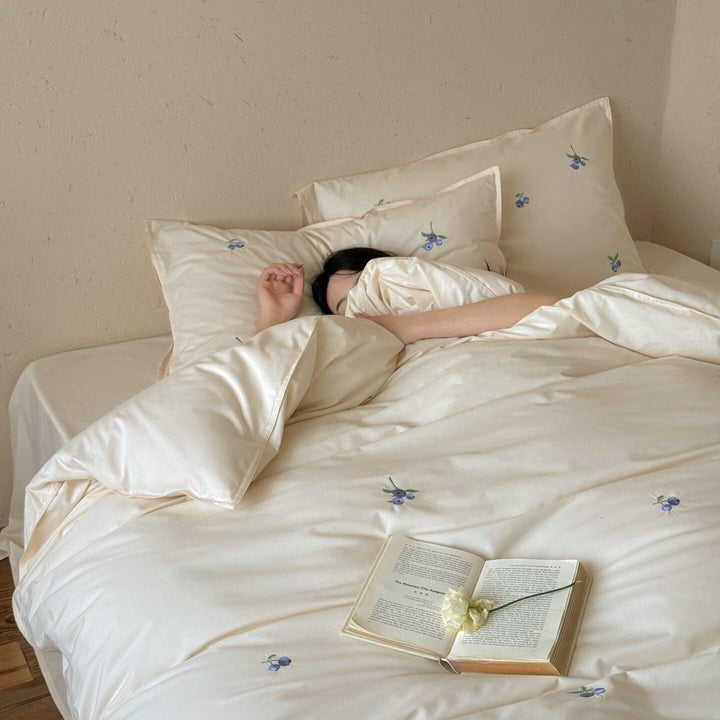 Luxurious cotton satin bedding set with delicate berry embroidery and silky-matte finish