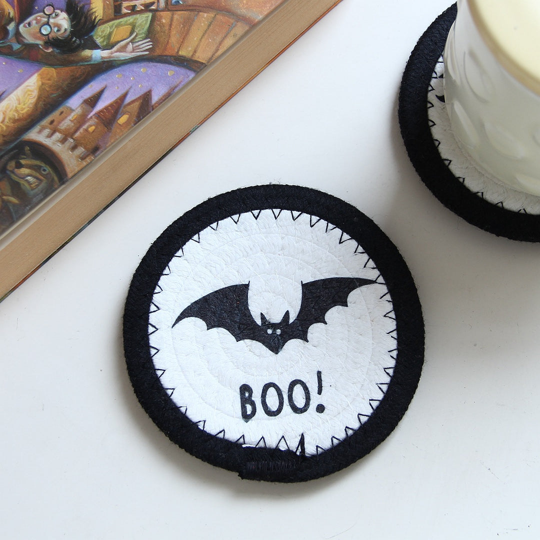 Round felt and cotton coasters with embroidered Halloween haunted house motif
