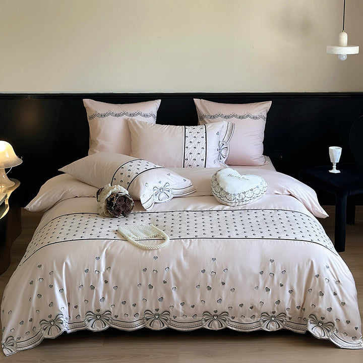 Romantic cotton satin bedding set with embroidered ribbon borders and decorative pillow