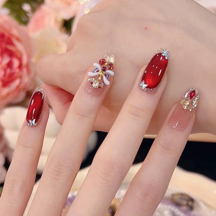 Artificial nail set with festive gift design and elegant glitter accents Kalsten