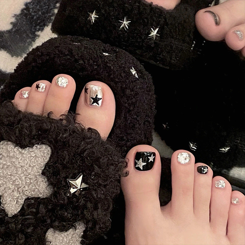 Artistic toenail art with rhinestone and glitter elements Kalsten