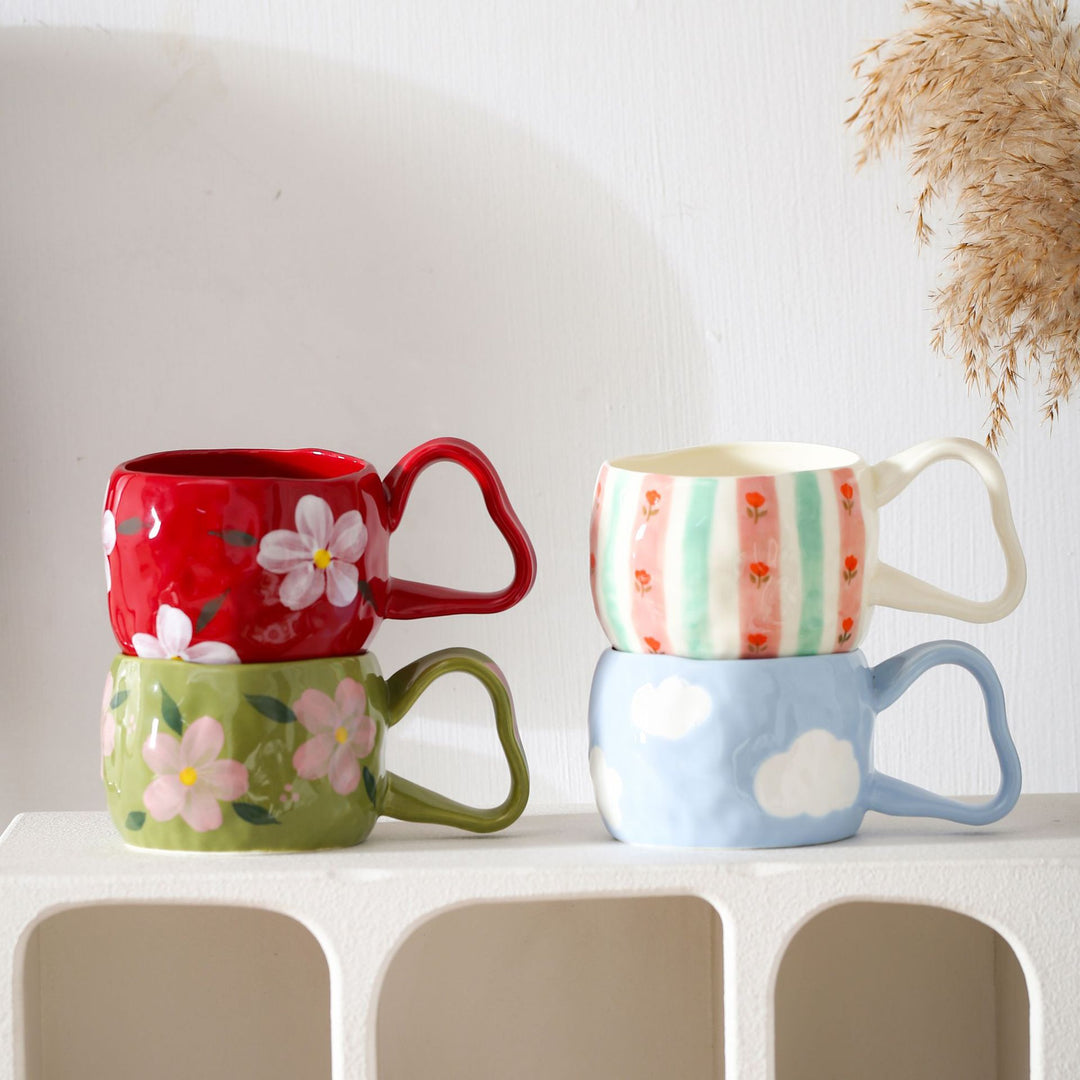 Ceramic mug with hand-painted stripes and flower design