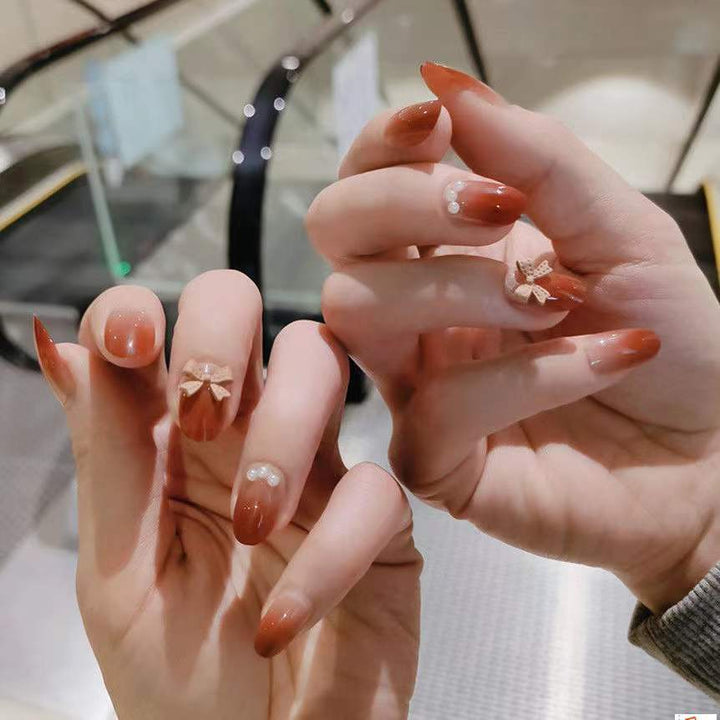 Artificial nails with glamorous bow and pearl decor Kalsten