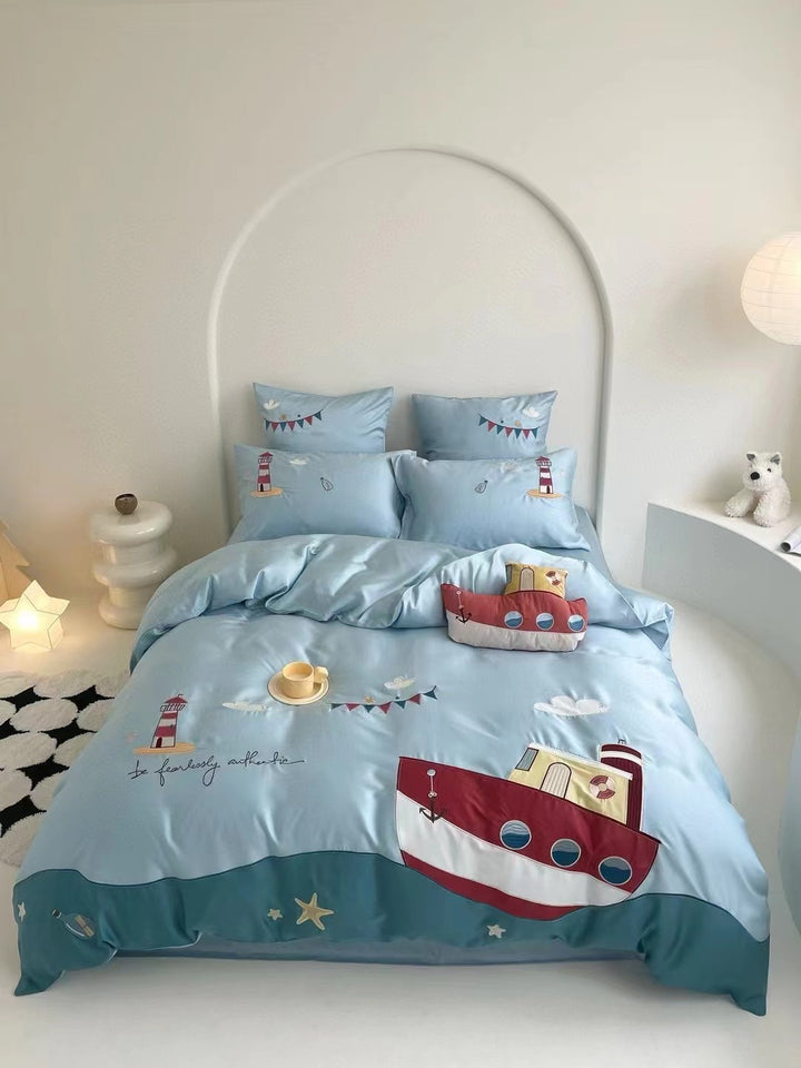 Children's bedding set with embroidered doll appliqués, ruffle and cuddle pillow