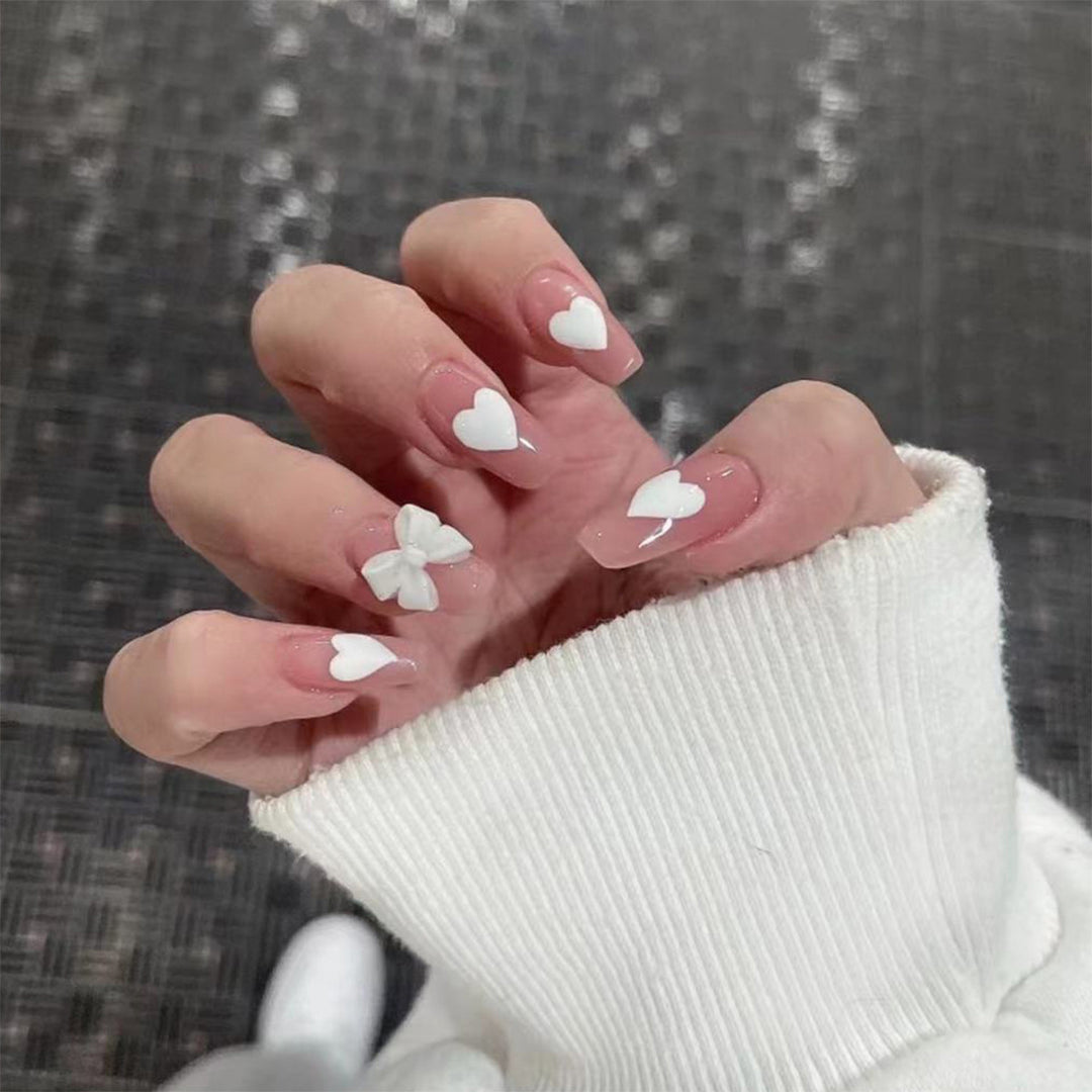 Artistic acrylic nails with heart and bow motifs Kalsten