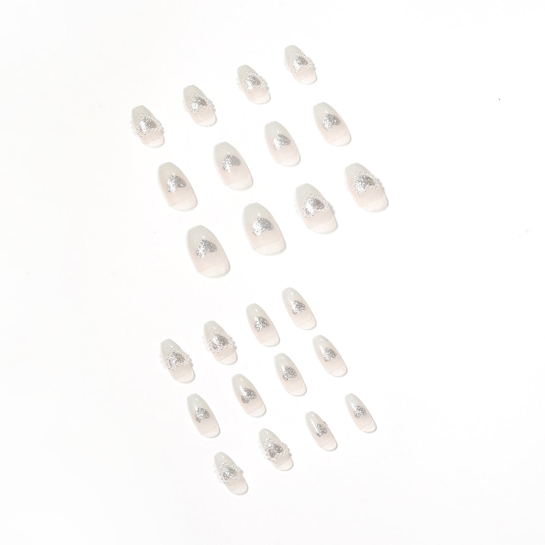 Artificial nail art with heart and rhinestone decorations Kalsten