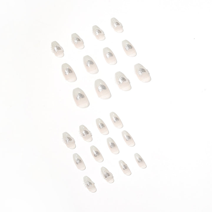 Artificial nail art with heart and rhinestone decorations Kalsten