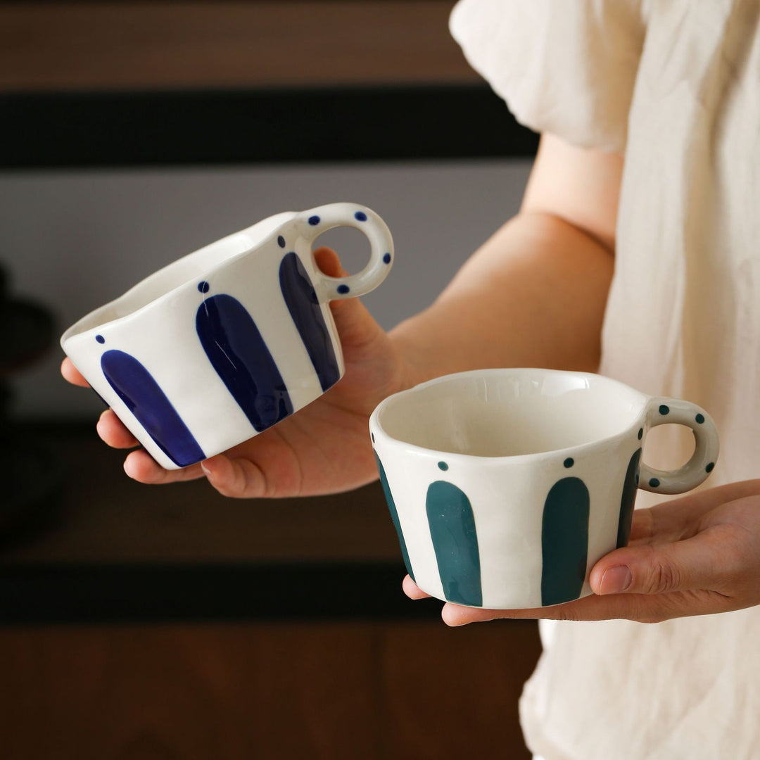 Handmade ceramic mug with ergonomic handle and wavy rim