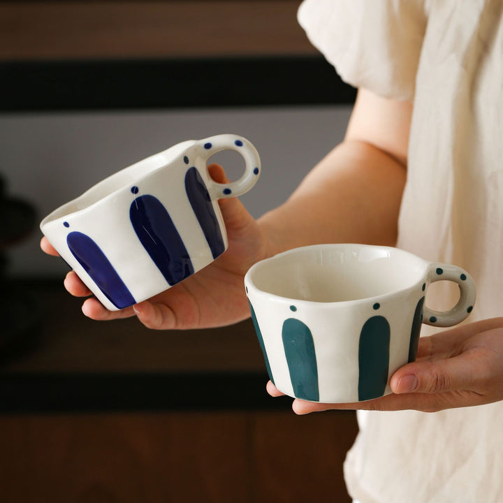 Handmade ceramic mug with ergonomic handle and wavy rim