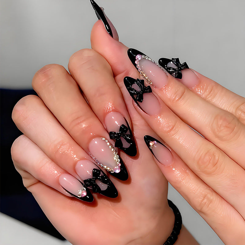 Artificial nail set with glamorous bow design and sparkling accents Kalsten