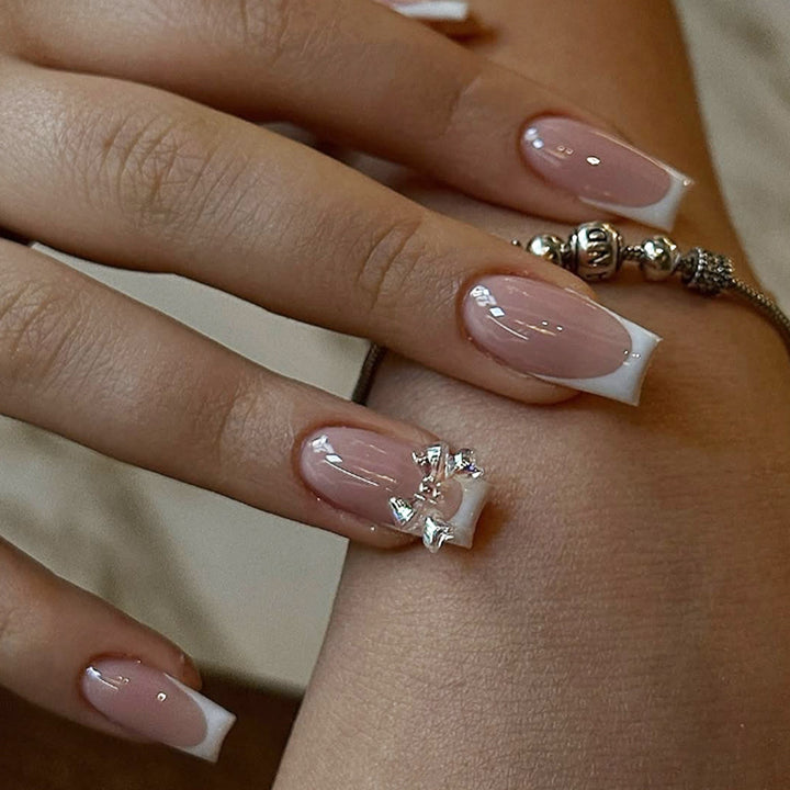 Artificial nail set with luxurious French tips and elegant jewelry embellishments Kalsten