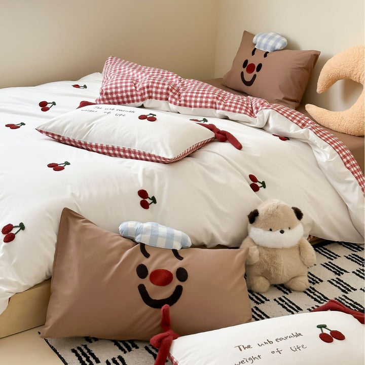 Children's bedding set with embroidered sprinkle appliqués, cuddle pillow and reversible function